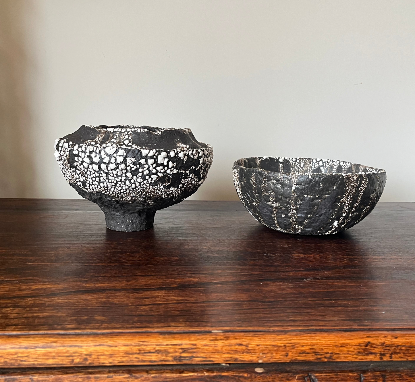 Large folded lip black stoneware bowl with white crawling glaze