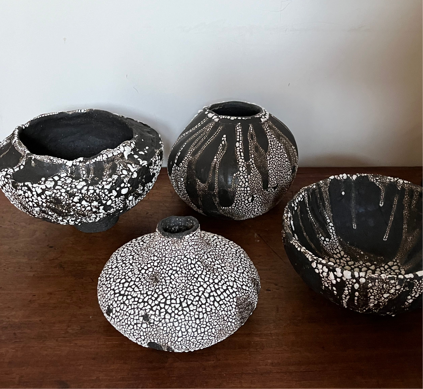 Large folded lip black stoneware bowl with white crawling glaze