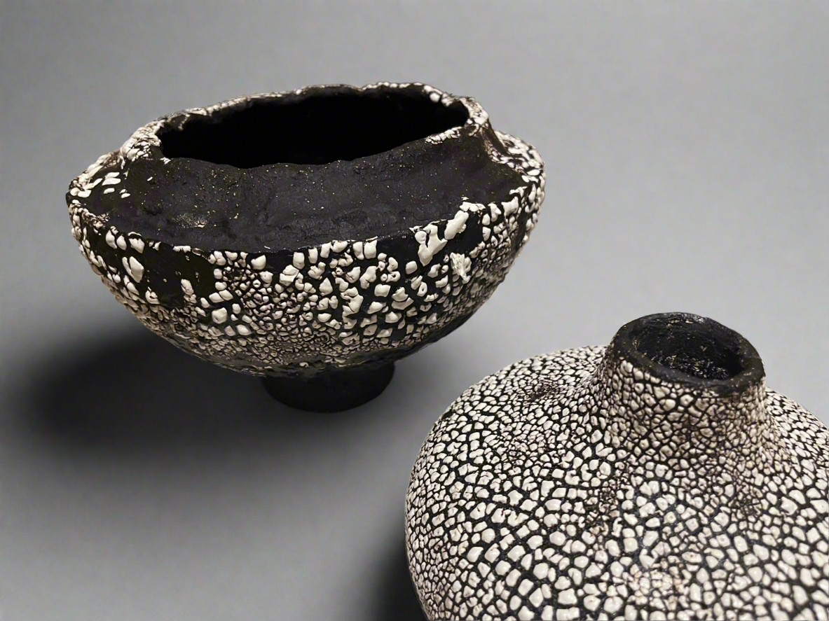 Large folded lip black stoneware bowl with white crawling glaze