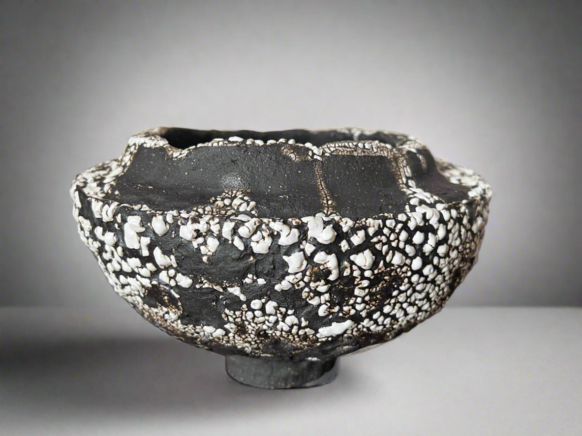 Large folded lip black stoneware bowl with white crawling glaze