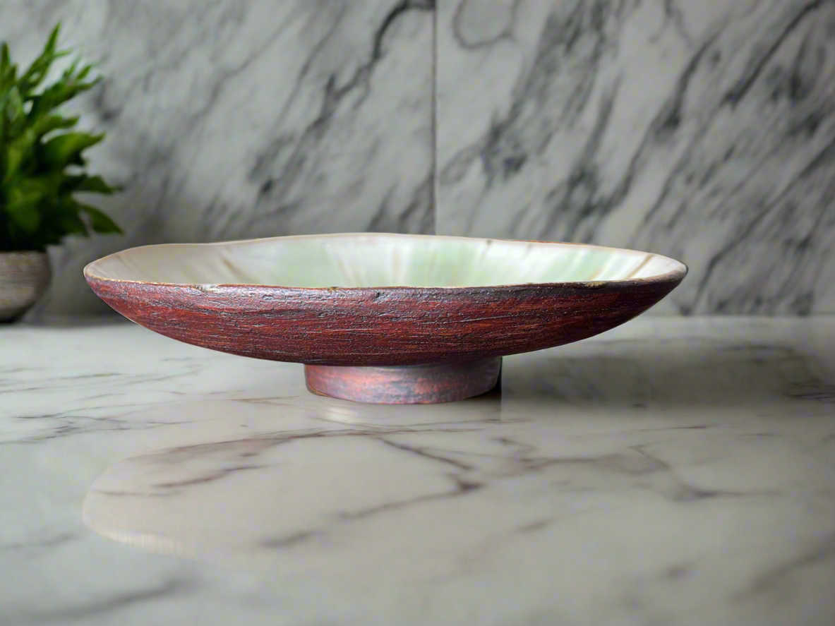 Shallow footed bowl in earthy creams and greens